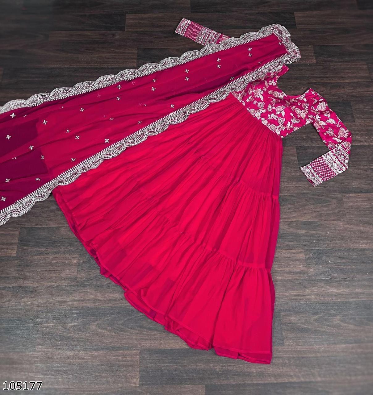 Red saree with white lace details on a wooden floor