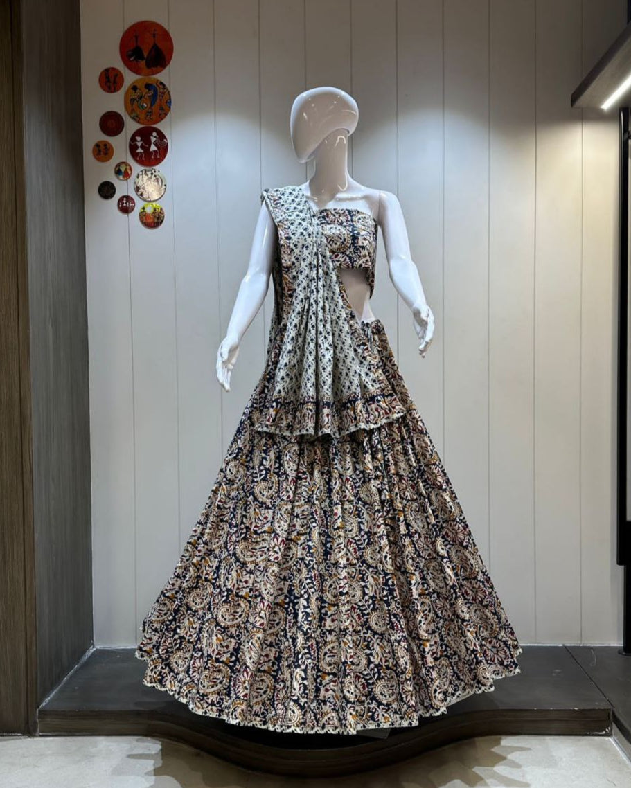 Mannequin wearing a patterned dress in a store setting with decorative elements on the wall.