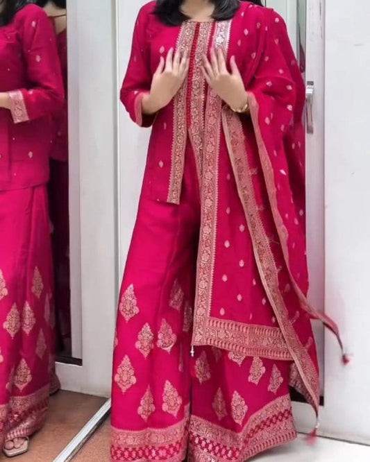Woman wearing a pink traditional outfit with gold patterns in a mirror reflection.