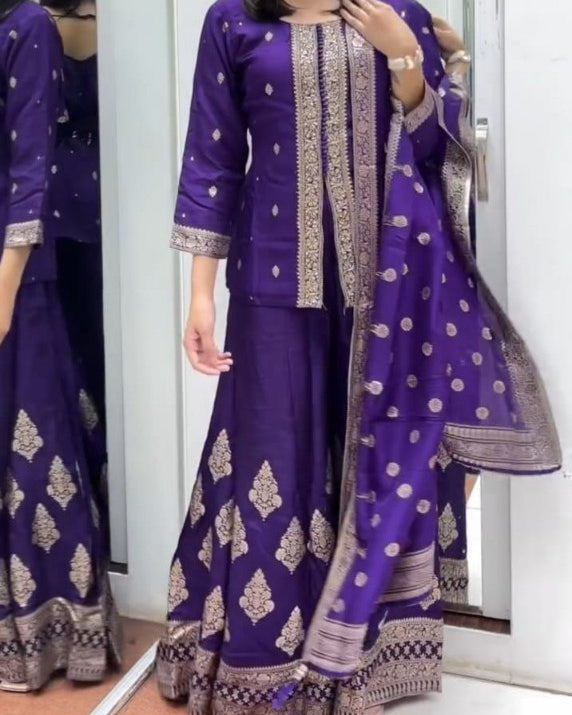 Woman wearing a purple traditional outfit with gold patterns in front of a mirror.