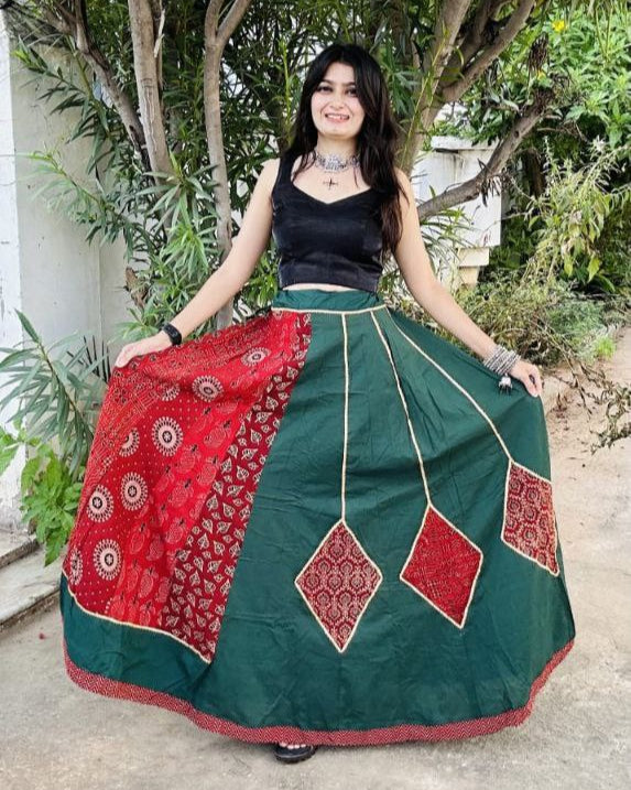 Woman wearing a green and red traditional outfit outdoors.