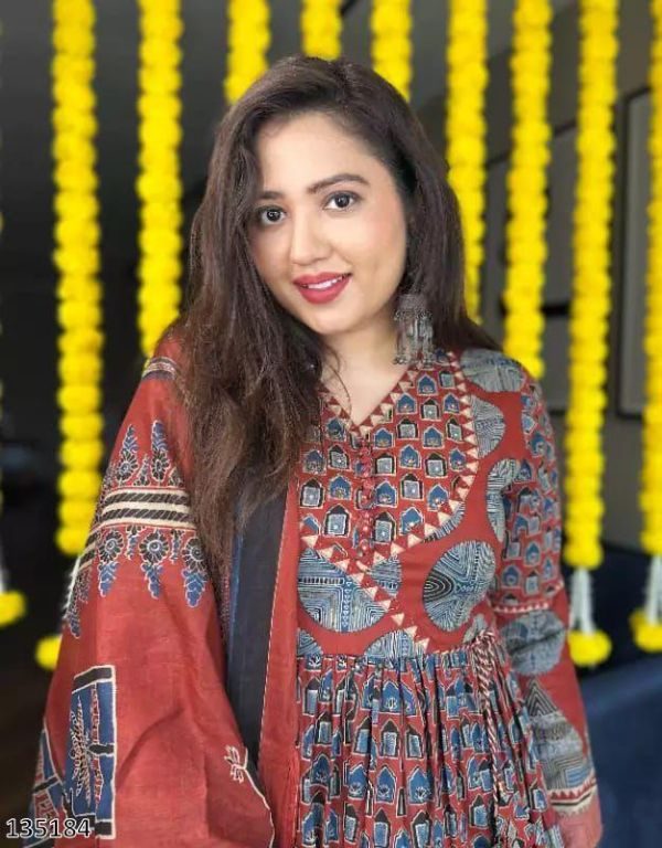 Woman in traditional outfit with decorative background