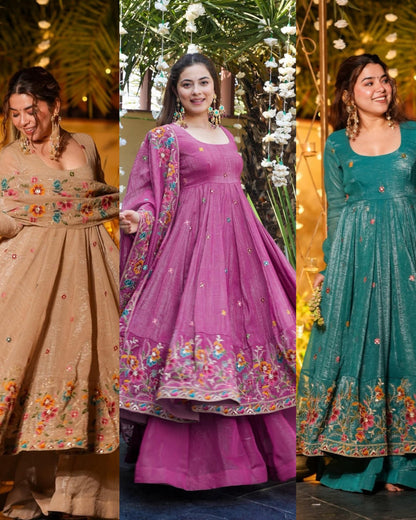 Three women wearing traditional embroidered gown palazzo dresses in beige, purple, and green.