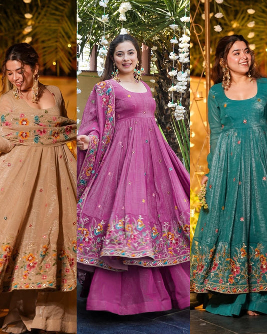 Three women wearing traditional embroidered gown palazzo dresses in beige, purple, and green.