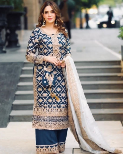 Woman in a traditional embroidered outfit standing on a city street.