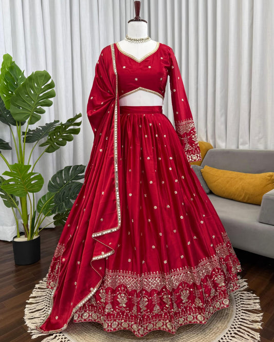 Red embroidered lehenga on a mannequin against a neutral background