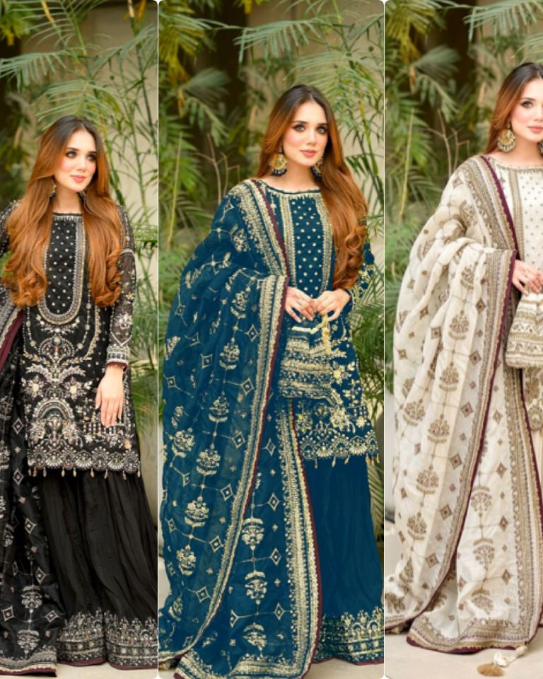 Three women in traditional outfits with intricate designs against a natural background.