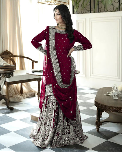 Woman in a red and silver traditional outfit standing in an elegant room with checkered floor and decorative elements.