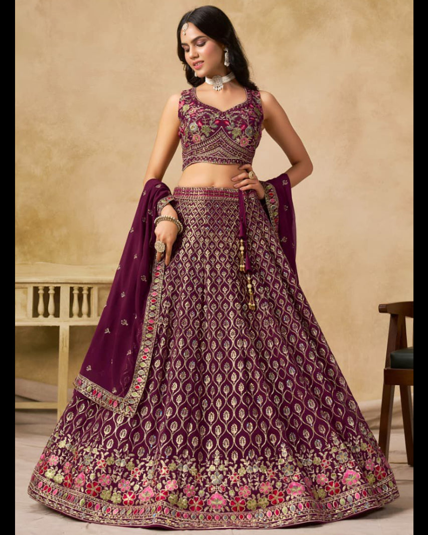 Woman wearing a traditional purple embroidered lehenga with a beige background