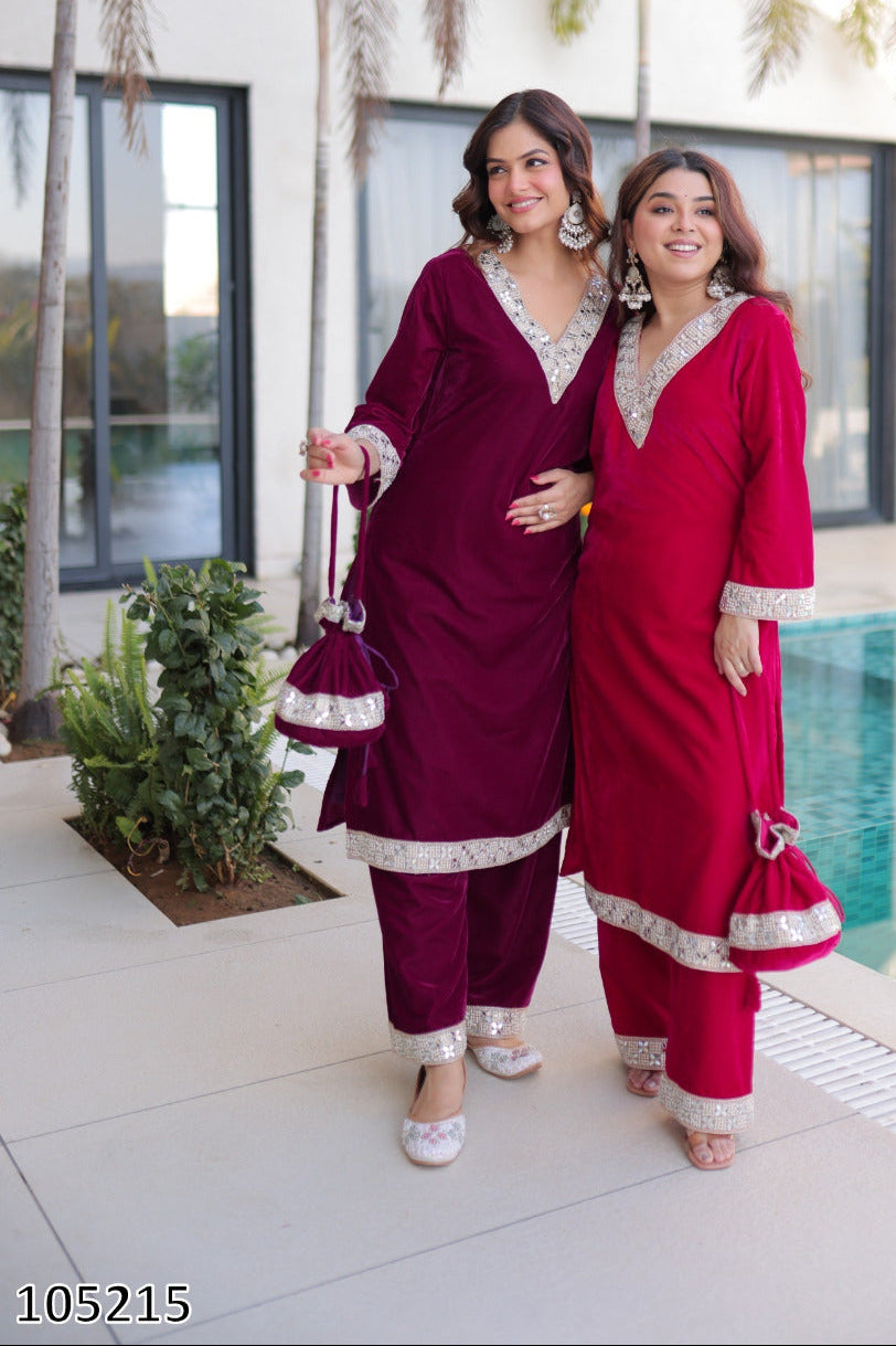 Two women in traditional outfits standing by a poolside with palm trees in the background.