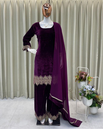 Mannequin wearing a purple traditional outfit with a draped fabric against a neutral background